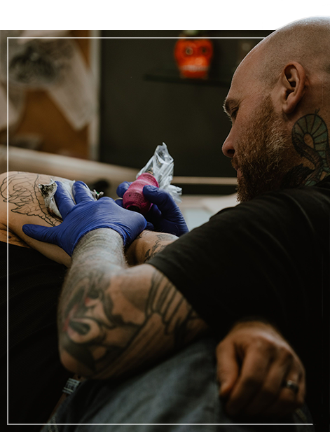 tattoo artist with client